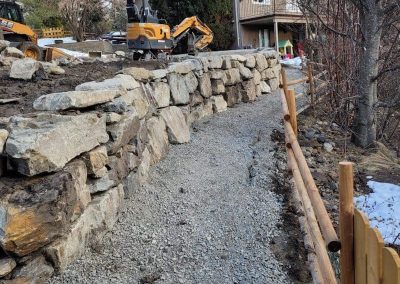 Kalagan Outdoor Design building stone wall in winter