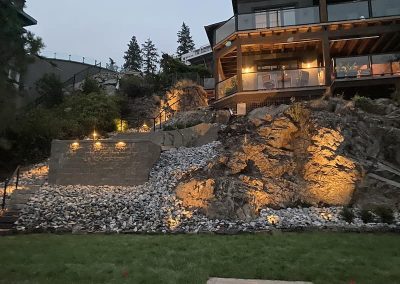Kalagan Outdoor Design steps up retaining wall front view with lighting